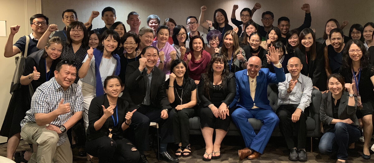 Douglas Mizzi with training attendees across Asia
